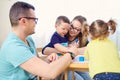 Mother, father and children draw together in the room Royalty Free Stock Photo