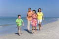 Mother, Father and Children Family Running Having Fun At Beach Royalty Free Stock Photo