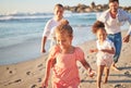 Mother, father and children running on beach in fun, play and race game on family summer holiday by sea or ocean. Smile Royalty Free Stock Photo