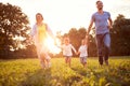 Mother and father with children running in nature Royalty Free Stock Photo