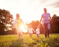 Mother and father with children running in nature Royalty Free Stock Photo