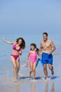 Mother, Father & Daughter Family Running on Beach Royalty Free Stock Photo