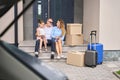 Mother, father and daughter are sitting on steps new home Royalty Free Stock Photo