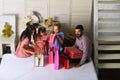 Mother, father and daughters with shopping bags and packs