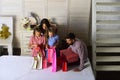 Mother, father and daughters with shopping bags and packs