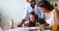 Mother and father drawing together with their child Royalty Free Stock Photo