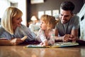 Mother and father enjoying with daughter inside