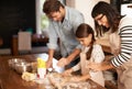 Mother, father and girl with baking cake in kitchen with oven, happiness and teaching with support. Family, parents and Royalty Free Stock Photo