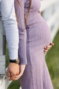 Mother and father hands holding pregnant belly. Third trimester of pregnancy Royalty Free Stock Photo