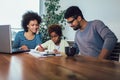 Mother and father helping daughter to do homework learning to calculate Royalty Free Stock Photo