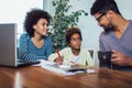 Mother and father helping daughter to do homework learning to calculate Royalty Free Stock Photo