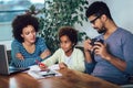 Mother and father helping daughter to do homework learning to calculate Royalty Free Stock Photo