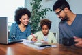 Mother and father helping daughter to do homework learning to calculate