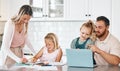 Mother and father helping daughters with homework together in the kitchen of a happy family house. Mom, dad and Royalty Free Stock Photo