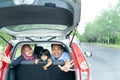 Mother, father, and his daughter inside a car look out from back windows Royalty Free Stock Photo