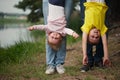 Mother and father holding children upside down Royalty Free Stock Photo