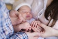 Mother and father holding hand of sleeping baby Royalty Free Stock Photo