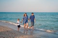 Mother father kid spending time together family vacation Parent dad mom walking with son enjoying sea beach Royalty Free Stock Photo