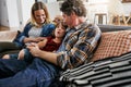 Mother, Father and kid talking on sofa in living room for love, quality time and relax together at home. Young boy Royalty Free Stock Photo