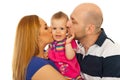 Mother and father kissing amazed baby Royalty Free Stock Photo