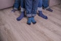 Mother, father and little child wearing blue jeans, blue socks,people legs isolated, body part, family togetherness Royalty Free Stock Photo