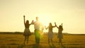 Mother, father and little daughter with sisters walking in the field in the sun. Happy young family. Children, dad and Royalty Free Stock Photo