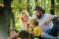 Mother father and little son sit forest picnic. Good day for spring picnic in nature. United with nature. Family day