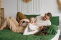 Mother and father are lying on the bed with their little son at home Royalty Free Stock Photo