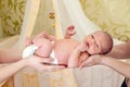 Mother and father's hands holding newborn baby