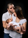 Mother and father smiling holding their newborn infant child baby boy Royalty Free Stock Photo