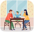 Mother, father and son playing board game together. Family members playing chess sitting at table Royalty Free Stock Photo