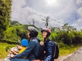 Mother, Father and son are traveling on a moped on a tea plantation in Malaysia. Traveling with children concept Royalty Free Stock Photo