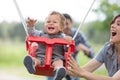 mother and father swinging baby Royalty Free Stock Photo