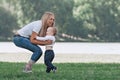 Mother, father and their little son are playing with the ball on the lawn. Royalty Free Stock Photo