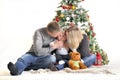 Mother, the father and their small child sits near Christmas tree Royalty Free Stock Photo