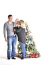 Mother, the father and their small child stand near Christmas tree Royalty Free Stock Photo