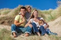 Mother, Father and Two Boys Family Sitting on a Beach Royalty Free Stock Photo