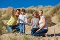 Mother, Father and Two Boys Family Vacation in Sand Dunes on a Beach Royalty Free Stock Photo