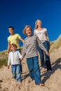 Mother, Father and Two Boys Family Walking in Sand Dunes on a Beach Royalty Free Stock Photo