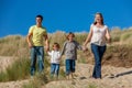 Mother, Father and Two Boys Family Walking in Sand Dunes on a Beach Royalty Free Stock Photo