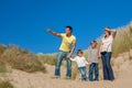 Mother, Father and Two Boys Family Walking in Sand Dunes on a Beach Royalty Free Stock Photo