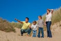 Mother, Father and Two Boys Family Walking in Sand Dunes on a Beach Royalty Free Stock Photo