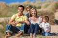 Mother, Father and Two Boys Sitting Having Fun At Beach Royalty Free Stock Photo