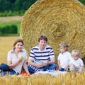 Mother, father and two little sons having picnic Royalty Free Stock Photo