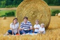 Mother, father and two little sons picnicking together Royalty Free Stock Photo