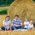 Mother, father and two little sons picnicking together Royalty Free Stock Photo