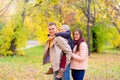 Mother and Father With Young Son On his back Autumn Park Royalty Free Stock Photo
