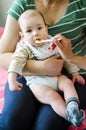 Mother feeding baby, baby infant eating from spoon Royalty Free Stock Photo