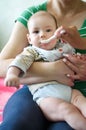 Mother feeding baby, baby infant eating from spoon Royalty Free Stock Photo