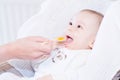 Mother feeding baby boy with baby spoon Royalty Free Stock Photo